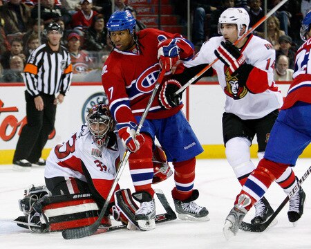 MONTREAL- OCTOBER 17:  Georges Laraque #17 of the Montreal Canadiens disrupts Pascal Leclaire #33 of the Ottawa Senators during the NHL game on October 17, 2009 at the Bell Centre in Montreal, Quebec, Canada.  The Senators defeated the Canadiens 3-1.  <br /><br /><span class="help">(Photo by Richard Wolowicz/Getty Images)</span>