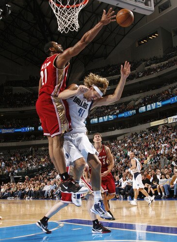 DALLAS - OCTOBER 17: Dirk Nowitzki #41 of the Dallas Mavericks goes up and is fouled against Darryl Watkins #20 of the Cleveland Cavaliers during a preseason game at the American Airlines Center on October 17, 2009 in Dallas, Texas. <br /><br /><span class="help">(Photo by Tim Heitman/NBAE via Getty Images)</span>