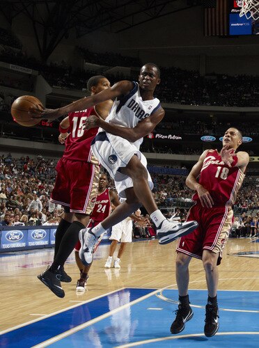 DALLAS - OCTOBER 17: Rodrigue Beaubois #3 of the Dallas Mavericks makes a pass outside to the shooter against Jamario Moon #15 and Anthony Parker #18 of the Cleveland Cavaliers during a preseason game at the American Airlines Center on October 17, 2009 in Dallas, Texas. <br /><br /><span class="help">(Photo by Glenn James/NBAE via Getty Images)</span>
