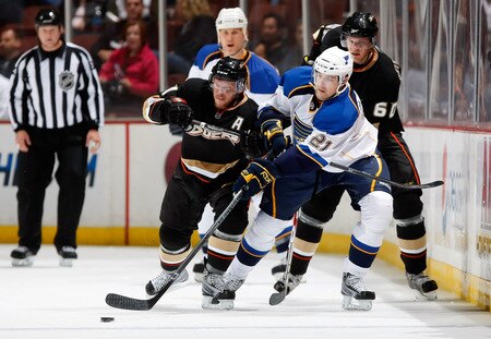 ANAHEIM, CA - OCTOBER 17:  (L-R) Saku Koivu #11 of the Anaheim Ducks and Patrik Berglund #21 of the St. Louis Blues battle for the puck as Brendan Mikkelson #60 of the Ducks pursues the play in the third period at Honda Center on October 17, 2009 in Anaheim, California. The Blues defeated the Ducks 5-0.  <br /><br /><span class="help">(Photo by Jeff Gross/Getty Images)</span>