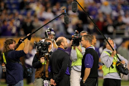 MINNEAPOLIS - OCTOBER 18:  The cameras and microphones of the media document the conversation as head coach Brad Childress (L) of the Minnesota Vikings and head coach Jim Harbaugh (R) of the Baltimore Ravens chat during warm ups prior to the NFL game at Hubert H. Humphrey Metrodome on October 18, 2009 in Minneapolis, Minnesota.  <br /><br /><span class="help">(Photo by Doug Pensinger/Getty Images)</span>