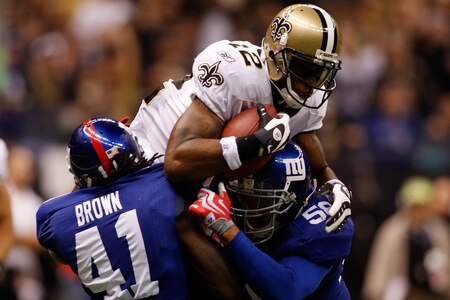 NEW ORLEANS - OCTOBER 18:  Marques Colston #12 of the New Orleans Saints makes a catch at the 1 yard line as he is tackled by C.C. Brown #41 and Antonio Pierce #58 of the New York Giants at the Louisiana Superdome on October 18, 2009 in New Orleans, Louisiana.  <br /><br /><span class="help">(Photo by Chris Graythen/Getty Images)</span>