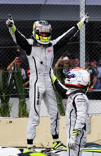 SAO PAULO, BRAZIL - OCTOBER 18:  Jenson Button (L) of Great Britain and Brawn GP is congratulated by team mate Rubens Barrichello (R) of Brazil and Brawn GP as he celebrates in parc ferme after clinching the F1 World Drivers Championship during the Brazilian Formula One Grand Prix at the Interlagos Circuit on October 18, 2009 in Sao Paulo, Brazil.  <br /><br /><span class="help">(Photo by Clive Mason/Getty Images)</span>