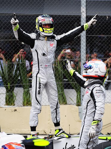 SAO PAULO, BRAZIL - OCTOBER 18:  Jenson Button (L) of Great Britain and Brawn GP is congratulated by team mate Rubens Barrichello (R) of Brazil and Brawn GP as he celebrates in parc ferme after clinching the F1 World Drivers Championship during the Brazilian Formula One Grand Prix at the Interlagos Circuit on October 18, 2009 in Sao Paulo, Brazil.  <br /><br /><span class="help">(Photo by Clive Mason/Getty Images)</span>