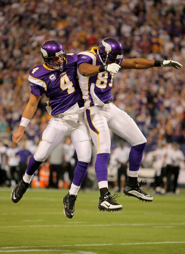 MINNEAPOLIS - OCTOBER 18:  Quarterback Brett Favre #4 celebrates his first quarter tocuhdown pass to wide receiver Visanthe Shiancoe #81 of the Minnesota Vikings against the Baltimore Ravens during NFL action at Hubert H. Humphrey Metrodome on October 18, 2009 in Minneapolis, Minnesota.  <br /><br /><span class="help">(Photo by Doug Pensinger/Getty Images)</span>