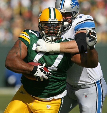 GREEN BAY, WI - OCTOBER 18: Cullen Jenkins #77 of the Green Bay Packers tries to run after intercepting a pass as Jeff Backus #76 of Detroit Lions drags him down at Lambeau Field on October 18, 2009 in Green Bay, Wisconsin. <br /><br /><span class="help">(Photo by Jonathan Daniel/Getty Images)</span>