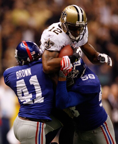NEW ORLEANS - OCTOBER 18:  Marques Colston #12 of the New Orleans Saints gets tackled by C.C. Brown #41 and Antonio Pierce #58 of the New York Giants at the Louisiana Superdome on October 18, 2009 in New Orleans, Louisiana.  <br /><br /><span class="help">(Photo by Chris Graythen/Getty Images)</span>