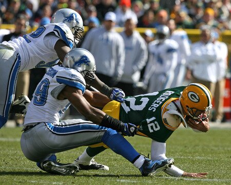 GREEN BAY, WI - OCTOBER 18: Aaron Rodgers #12 of the Green Bay Packers is sacked by Cliff Avril #92 (L) and Julian Peterson #59 of Detroit Lions at Lambeau Field on October 18, 2009 in Green Bay, Wisconsin. <br /><br /><span class="help">(Photo by Jonathan Daniel/Getty Images)</span>