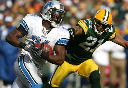 GREEN BAY, WI - OCTOBER 18: Kevin Smith #34 of the Detroit Lions runs the ball as Charles Woodson #21 of the Green Bay Packers reaches in to slow him down at Lambeau Field on October 18, 2009 in Green Bay, Wisconsin. The Packers defeated the Lions 26-0. <br /><br /><span class="help">(Photo by Jonathan Daniel/Getty Images)</span>