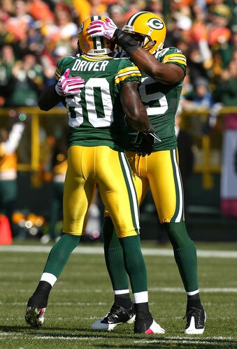 GREEN BAY, WI - OCTOBER 18: Donald Driver #80 of the Green Bay Packers is hugged by teammate Greg Jennings #85 after breaking the Packers all-time receiving record in the 1st quarter against the Detroit Lions at Lambeau Field on October 18, 2009 in Green Bay, Wisconsin. The Packers defeated the Lions 26-0.  <br /><br /><span class="help">(Photo by Jonathan Daniel/Getty Images)</span>