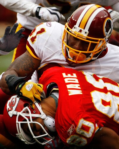 LANDOVER, MD - OCTOBER 18:  Kareem Moore #41 of the Washington Redskins tackles Bobby Wade #80 of the Kansas City Chiefs during their game October 18, 2009 at FedEx Field in Landover, Maryland. Kansas City kicker Ryan Succop had 4 field goals as the Chiefs won the game 14-6.  <br /><br /><span class="help">(Photo by Win McNamee/Getty Images)</span>