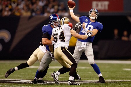 NEW ORLEANS - OCTOBER 18:  Eli Manning #10 of the New York Giants throws under pressure from Troy Evans #54 of the New Orleans Saints at the Louisiana Superdome on October 18, 2009 in New Orleans, Louisiana.  The Saints defeated the Giants 48-27.  <br /><br /><span class="help">(Photo by Chris Graythen/Getty Images)</span>