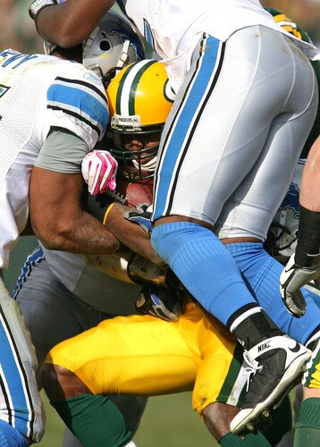 GREEN BAY, WI - OCTOBER 18: Ryan Grant #25 of the Green Bay Packers is gang-tackled by members of the Detroit Lion defense at Lambeau Field on October 18, 2009 in Green Bay, Wisconsin. The Packers defeated the Lions 26-0. <br /><br /><span class="help">(Photo by Jonathan Daniel/Getty Images)</span>