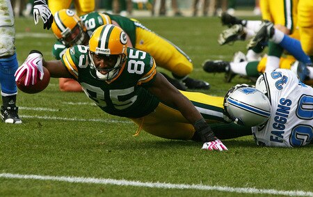 GREEN BAY, WI - OCTOBER 18: Greg Jennings #85 of the Green Bay Packers stretches to reach the goal line as he's tackled by Demarcus Faggins #38 of the Detroit Lions at Lambeau Field on October 18, 2009 in Green Bay, Wisconsin. The Packers defeated the Lions 26-0. <br /><br /><span class="help">(Photo by Jonathan Daniel/Getty Images)</span>