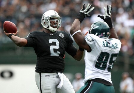 OAKLAND, CA - OCTOBER 18:   JaMarcus Russell #2 of the Oakland Raiders passes against Victor Abiamiri #95 of the Philadelphia Eagles during an NFL game at the Oakland-Alameda County Coliseum on October 18, 2009 in Oakland, California. <br /><br /><span class="help">(Photo by Jed Jacobsohn/Getty Images)</span>