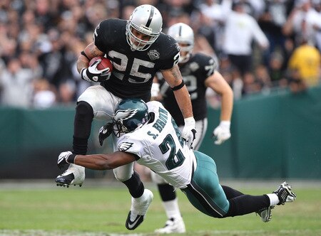 OAKLAND, CA - OCTOBER 18:  Justin Fargas #25 of the Oakland Raiders runs against Sheldon Brown #24 of the Philadelphia Eagles during an NFL game at the Oakland-Alameda County Coliseum on October 18, 2009 in Oakland, California.  <br /><br /><span class="help">(Photo by Jed Jacobsohn/Getty Images)</span>