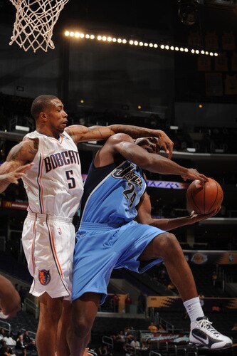 LOS ANGELES - OCTOBER 18:  Paul Millsap #24 of the Utah Jazz has his shot challenged by Antonio Anderson #5 of the Charlotte Bobcats at Staples Center on October 18, 2009 in Los Angeles, California. <br /><br /><span class="help">(Photo by Noah Graham/NBAE via Getty Images)</span>
