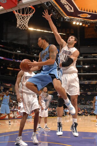 LOS ANGELES - OCTOBER 18:  Deron Williams #8 of the Utah Jazz has his shot challenged by Vladimir Radmanovic #10 of the Charlotte Bobcats at Staples Center on October 18, 2009 in Los Angeles, California. <br /><br /><span class="help">(Photo by Noah Graham/NBAE via Getty Images)</span>