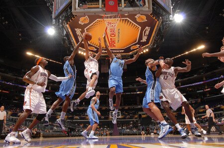 LOS ANGELES - OCTOBER 18:  D.J. Augustin #14 of the Charlotte Bobcats goes up for a shot between Ronnie Brewer #9 and Paul Millsap #24 of the Utah Jazz at Staples Center on October 18, 2009 in Los Angeles, California. <br /><br /><span class="help">(Photo by Noah Graham/NBAE via Getty Images)</span>