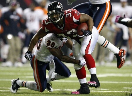 ATLANTA - OCTOBER 18: Running back Michael Turner #33 of the Atlanta Falcons is tackled by safety Danieal Manning #38 of the Chicago Bears in the second quarter of the game at the Georgia Dome on October 18, 2009 in Atlanta, Georgia. <br /><br /><span class="help">(Photo by Kevin C. Cox/Getty Images)</span>