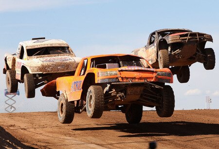 WITTMANN, AZ - OCTOBER 18:  LOORRS unlimited 4 drivers Adrianne Cenni (C) leads Carl Renezeder (L) and Alan Pflueger (R) in the Lucas Oil Off Road Racing Series on October 18, 2009 at the Speedworld Off Road Park in Wittmann, Arizona  <br /><br /><span class="help">(Photo by Christian Petersen/Getty Images)</span>