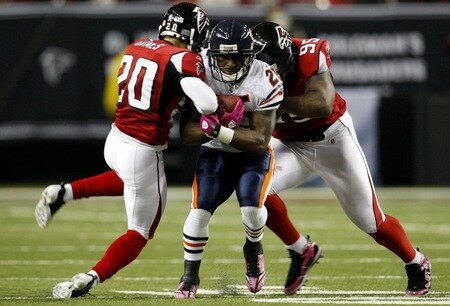 ATLANTA - OCTOBER 18:  Running back Garrett Wolfe #25 of the Chicago Bears runs through Brent Grimes #20 and Jonathan Babineaux #95 of the Atlanta Falcons during the third quarter of the game at the Georgia Dome on October 18, 2009 in Atlanta, Georgia. <br /><br /><span class="help">(Photo by Kevin C. Cox/Getty Images)</span>