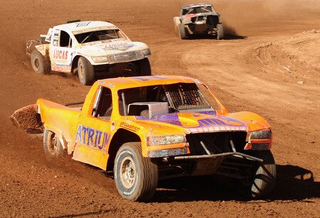 WITTMANN, AZ - OCTOBER 18:  LOORRS unlimited 4 drivers Adrianne Cenni (C) leads Carl Renezeder (L) and Alan Pflueger (R) in the Lucas Oil Off Road Racing Series on October 18, 2009 at the Speedworld Off Road Park in Wittmann, Arizona  <br /><br /><span class="help">(Photo by Christian Petersen/Getty Images)</span>