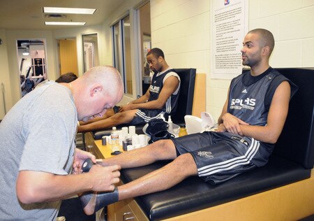 SAN ANTONIO - OCTOBER 19: Tony Parker (near) and Malik Hairston of the San Antonio Spurs gets taped during training camp on October 19, 2009 at the AT&T Center in San Antonio, Texas. <br /><br /><span class="help">(Photo by D. Clarke Evans/NBAE via Getty Images)</span>