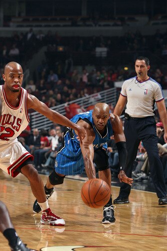 CHICAGO - OCTOBER 19:  Vince Carter #15 of the Orlando Magic passes against Taj Gibson #22 of the Chicago Bulls during a pre-season game on October 19, 2009 at the United Center in Chicago, Illinois.  <br /><br /><span class="help">(Photo by Gary Dineen/NBAE via Getty Images)</span>