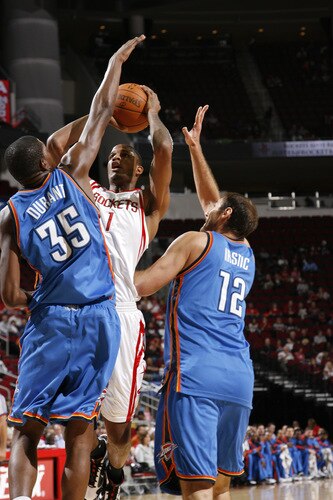 HOUSTON - OCTOBER 19:  Trevor Ariza #1 of the Houston Rockets shoots the ball over Kevin Durant #35 and Nenad Krstic #12 of the Oklahoma City Thunder on October 19, 2009 at the Toyota Center in Houston, Texas. <br /><br /><span class="help">(Photo by Bill Baptist/NBAE via Getty Images)</span>
