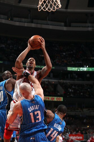 CHICAGO - OCTOBER 19: James Johnson #16 of the Chicago Bulls attempts a layup against (L-R) Mikael Pietrus #3, Marcin Gortat #13, and Jameer Nelson #14 of the Orlando Magic during a pre-season game on October 19, 2009 at the United Center in Chicago, Illinois.  <br /><br /><span class="help">(Photo by Gary Dineen/NBAE via Getty Images)</span>