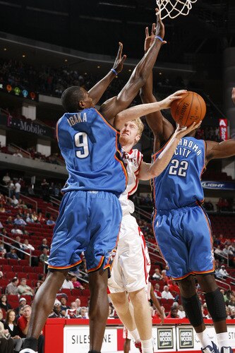 HOUSTON - OCTOBER 19: Chase Budinger #10 of the Houston Rockets shoots the ball over Serge Ibaka #9 and Jeff Green #22 of the Oklahoma City Thunder on October 19, 2009 at the Toyota Center in Houston, Texas. <br /><br /><span class="help">(Photo by Bill Baptist/NBAE via Getty Images)</span>