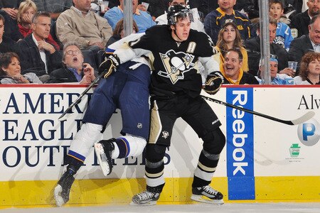 PITTSBURGH - OCTOBER 20:  Forward Evgeni Malkin #71 of the Pittsburgh Penguins finishes a check on Tyson Strachan #33 of the St. Louis Blues in the first period on October 20, 2009 at Mellon Arena in Pittsburgh, Pennsylvania.  <br /><br /><span class="help">(Photo by Jamie Sabau/Getty Images)</span>