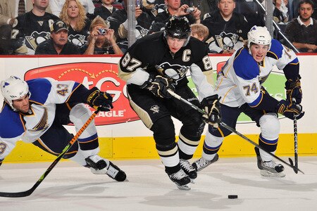 PITTSBURGH - OCTOBER 20: Forward Sidney Crosby #87 of the Pittsburgh Penguins controls the puck as Mike Weaver #43 and TJ Oshie #74 of the St. Louis Blues defend on October 20, 2009 at Mellon Arena in Pittsburgh, Pennsylvania.  <br /><br /><span class="help">(Photo by Jamie Sabau/Getty Images)</span>