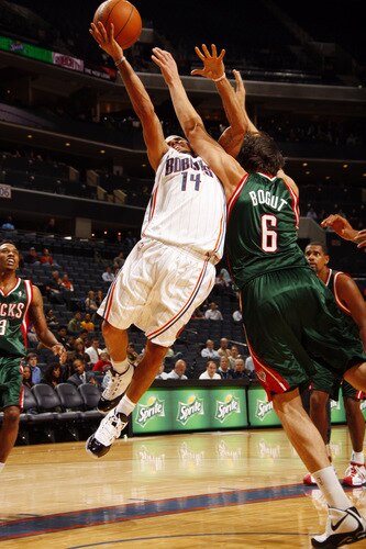 CHARLOTTE, NC - OCTOBER 20  D.J. Augustin #14 of the Charlotte Bobcats shoots against Andrew Bogut #6 of the Milwaukee Bucks on October 20, 2009 at Time Warner Cable Arena in Charlotte, North Carolina.  <br /><br /><span class="help">(Photo by Kent Smith/NBAE via Getty Images)</span>