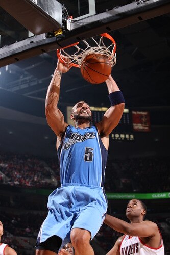 PORTLAND, OR - OCTOBER 20: Carlos Boozer #5 of the Utah Jazz dunks the ball over Jarron Collins #9 of the Portland Trail Blazers in a preseason game on October 20, 2009 at the Rose Garden Arena in Portland, Oregon. <br /><br /><span class="help">(Photo by Sam Forencich/NBAE via Getty Images)</span>