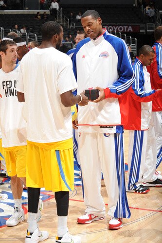 LOS ANGELES - OCTOBER 20:  Marcus Camby #23 of the Los Angeles Clippers exchanges gifts with a Maccabi Electra Tel Aviv player before their game at Staples Center on October 20, 2009 in Los Angeles, California. <br /><br /><span class="help">(Photo by Noah Graham/NBAE via Getty Images)</span>
