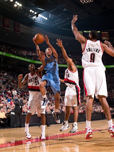 PORTLAND, OR - OCTOBER 20: Eric Maynor #3 of the Utah Jazz goes up for a shot over Jarron Collins #9 of the Portland Trail Blazers during a preseason game on October 20, 2009 at the Rose Garden Arena in Portland, Oregon. <br /><br /><span class="help">(Photo by Sam Forencich/NBAE via Getty Images)</span>