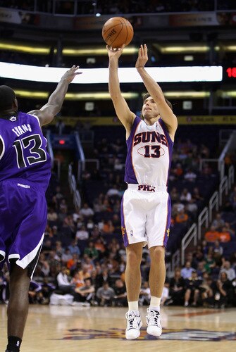 PHOENIX - OCTOBER 20:  Steve Nash #13 of the Phoenix Suns puts up a three point shot over Tyreke Evans #13 of the Sacramento Kings during the NBA preseason game at US Airways Center on October 20, 2009 in Phoenix, Arizona. The Suns defeated the Kings 143-127.  <br /><br /><span class="help">(Photo by Christian Petersen/Getty Images)</span>