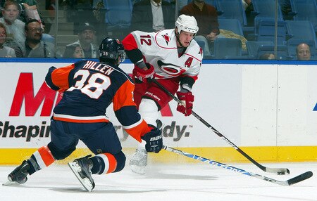 UNIONDALE, NY - OCTOBER 21:  Eric Staal #12 of the Carolina Hurricanes skates against Jack Hillen #38 of the New York Islanders on October 21, 2009 at Nassau Coliseum in Uniondale, New York.  <br /><br /><span class="help">(Photo by Jim McIsaac/Getty Images)</span>