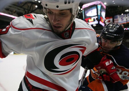 UNIONDALE, NY- OCTOBER 21: Chad LaRose #59 of the Carolina Hurricanes fights for the puck against Jack Hillen #38 of the New York Islanders during the game on October 21, 2009 at  in Uniondale, NY.  <br /><br /><span class="help">(Photo by Jared Wickerham/Getty Images)</span>