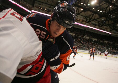 UNIONDALE, NY- OCTOBER 21: Andy Sutton #25 of the New York Islanders checks Matt Cullen #8 of the Carolina Hurricanes against the boards during the game on October 21, 2009 at  in Uniondale, NY.  <br /><br /><span class="help">(Photo by Jared Wickerham/Getty Images)</span>