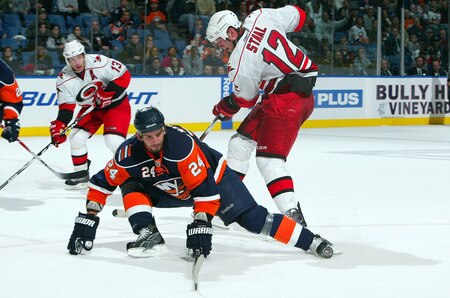 UNIONDALE, NY - OCTOBER 21:  Eric Staal #12 of the Carolina Hurricanes is unable to move the puck past Radek Martinek #24 of the New York Islanders on October 21, 2009 at Nassau Coliseum in Uniondale, New York. The Isles won the game 4-3 after a shoot out.  <br /><br /><span class="help">(Photo by Jim McIsaac/Getty Images)</span>