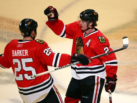 CHICAGO - OCTOBER 21: Duncan Keith #2 of the Chicago Blackhawks celebrates his first period goal with teammate Cameron Barker #25 against the Vancouver Canucks at the United Center on October 14, 2009 in Chicago, Illinois. <br /><br /><span class="help">(Photo by Jonathan Daniel/Getty Images)</span>