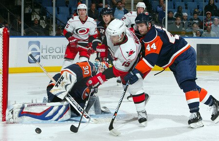 UNIONDALE, NY - OCTOBER 21:  Tuomo Ruutu #15 of the Carolina Hurricanes is stopped on his scoring chance by Dwayne Roloson #30 and Freddy Meyer #44 of the New York Islanders on October 21, 2009 at Nassau Coliseum in Uniondale, New York. The Isles won the game 4-3 after a shoot out.  <br /><br /><span class="help">(Photo by Jim McIsaac/Getty Images)</span>
