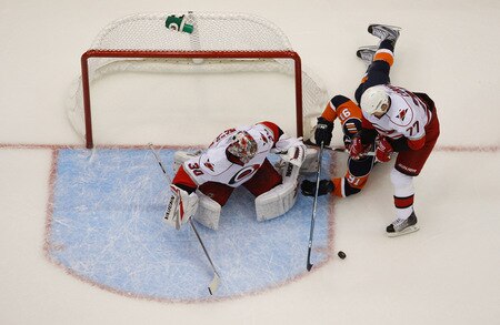 UNIONDALE, NY- OCTOBER 21: John Tavares #91 of the New York Islanders dives for the puck in front of Cam Ward #30 and Joe Corvo #77 of the Carolina Hurricanes during the game on October 21, 2009 at  in Uniondale, NY.  <br /><br /><span class="help">(Photo by Jared Wickerham/Getty Images)</span>