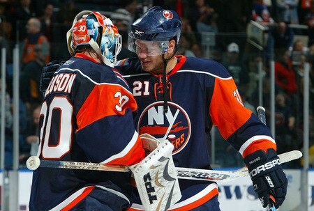 UNIONDALE, NY - OCTOBER 21:  Kyle Okposo #21 and Dwayne Roloson #30 of the New York Islanders celebrate after defeating the Carolina Hurricanes on October 21, 2009 at Nassau Coliseum in Uniondale, New York. The Isles won the game 4-3 after a shoot out.  <br /><br /><span class="help">(Photo by Jim McIsaac/Getty Images)</span>