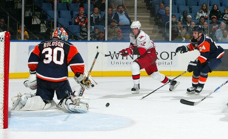 UNIONDALE, NY - OCTOBER 21:  Eric Staal #12 of the Carolina Hurricanes is stopped by Dwayne Roloson #30 and Radek Martinek #24 of the New York Islanders on October 21, 2009 at Nassau Coliseum in Uniondale, New York. The Isles won the game 4-3 after a shoot out.  <br /><br /><span class="help">(Photo by Jim McIsaac/Getty Images)</span>