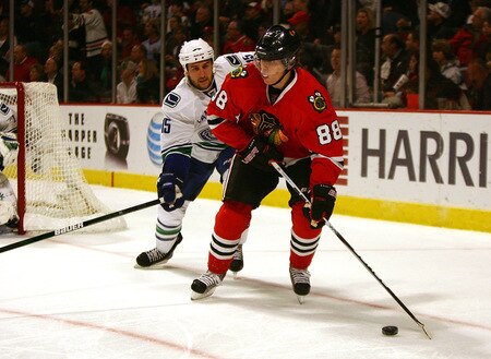 CHICAGO - OCTOBER 21: Patrick Kane #88 of the Chicago Blackhawks looks to pass under pressure from Tanner Glass #15 of the Vancouver Canucks at the United Center on October 14, 2009 in Chicago, Illinois. <br /><br /><span class="help">(Photo by Jonathan Daniel/Getty Images)</span>