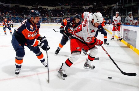 UNIONDALE, NY - OCTOBER 21:  Chad LaRose #59 of the Carolina Hurricanes controls the puck against Radek Martinek #24 of the New York Islanders on October 21, 2009 at Nassau Coliseum in Uniondale, New York. The Isles won the game 4-3 after a shoot out.  <br /><br /><span class="help">(Photo by Jim McIsaac/Getty Images)</span>